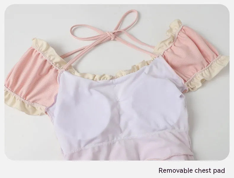 Pink women's one-piece swimsuit with conservative Siamese style design