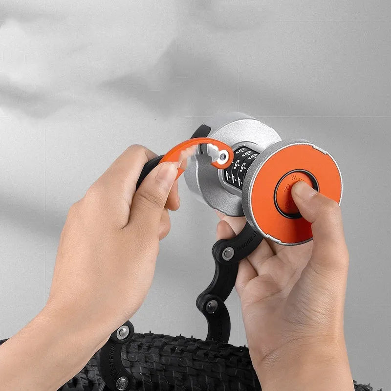 Portable black and black orange bicycle folding lock with multi-material construction.