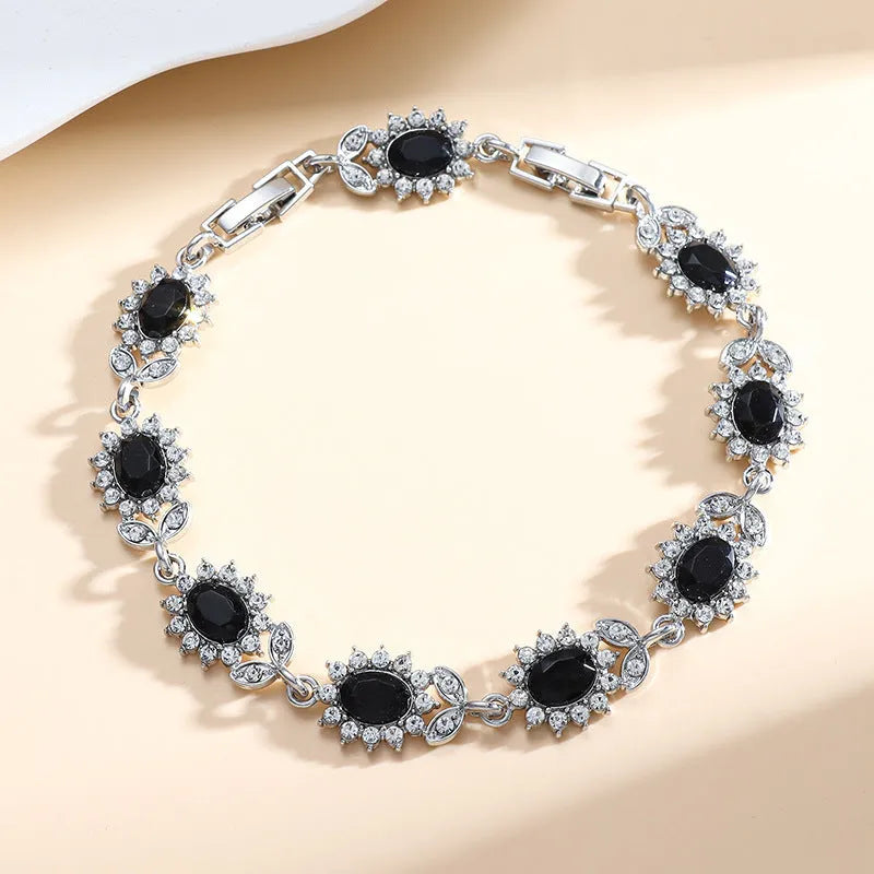Women's bracelet with inlaid zircon gemstones in multiple colours on environmentally friendly alloy band