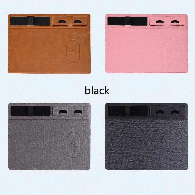 Pink PU leather wireless charging mouse pad with integrated phone holder on a desk.