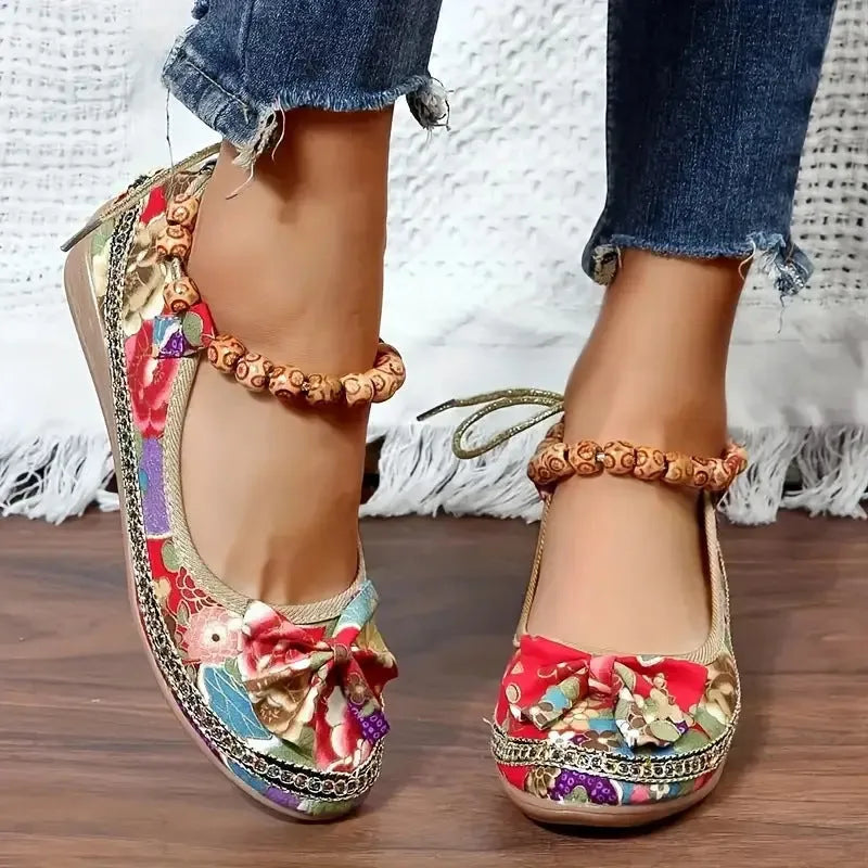 Women's ethnic platform sandals with elastic band closure in black colour showing cloth upper and round toe design