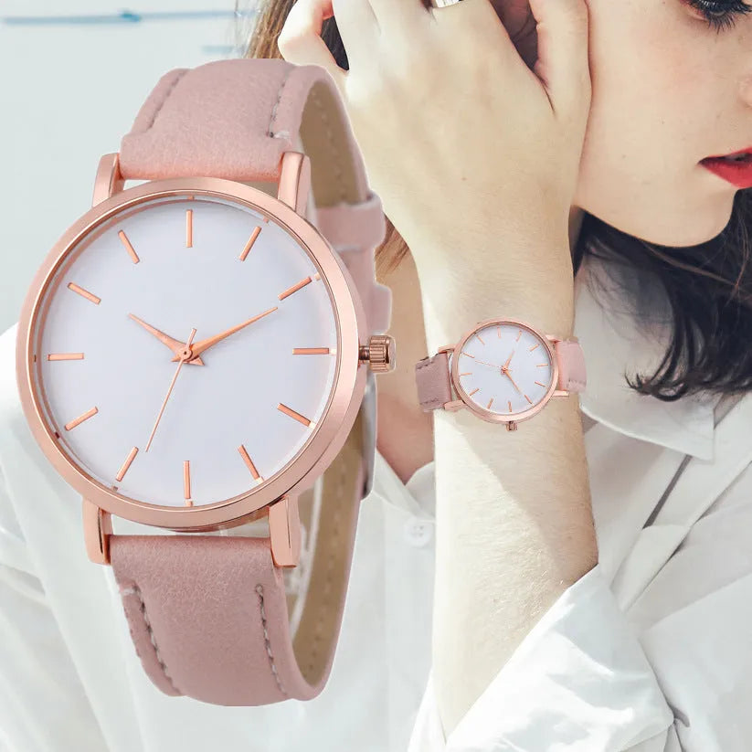 Square-faced quartz watch with a PU leather strap on a wrist, showing colour options like grey, pink, and blue.