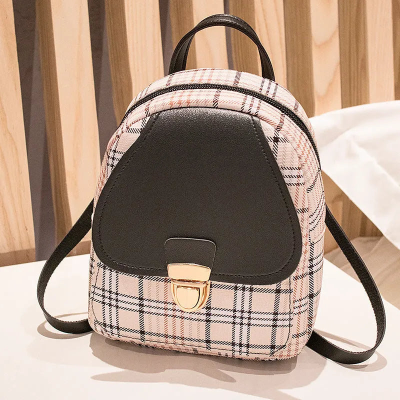 A black one shoulder diagonal phone bag made from PU fabric, shown being worn.