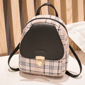 A black one shoulder diagonal phone bag made from PU fabric, shown being worn.