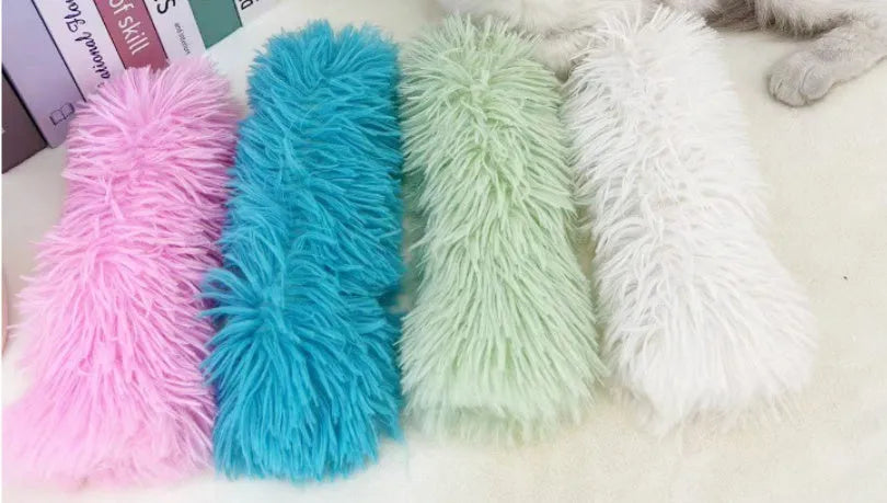 Plush cat toy pillow with crinkle paper in blue, green, pink and white colours measuring 27cm by 10cm