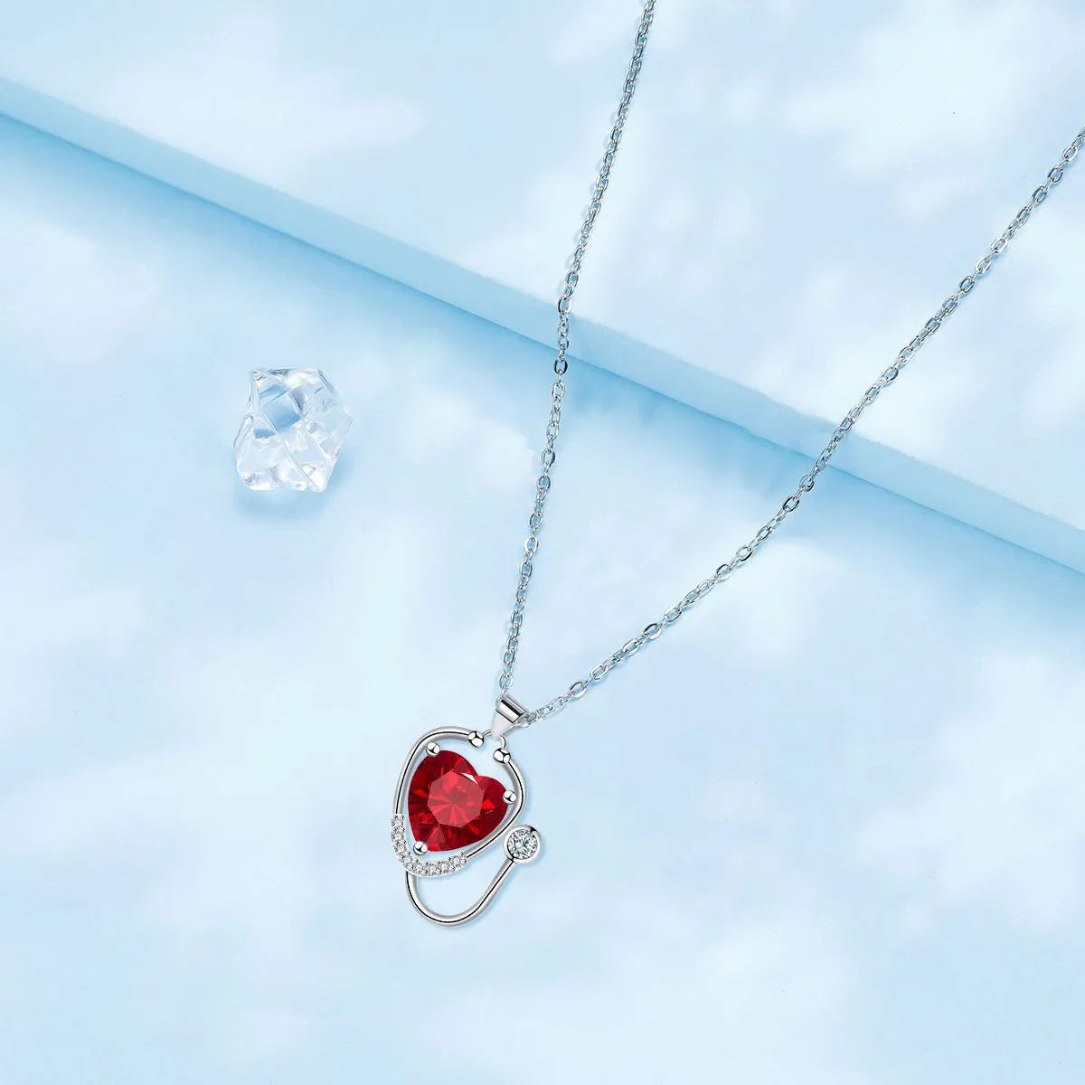 Women's fashion necklace with wings, cross and stethoscope design in red diamond colour on copper