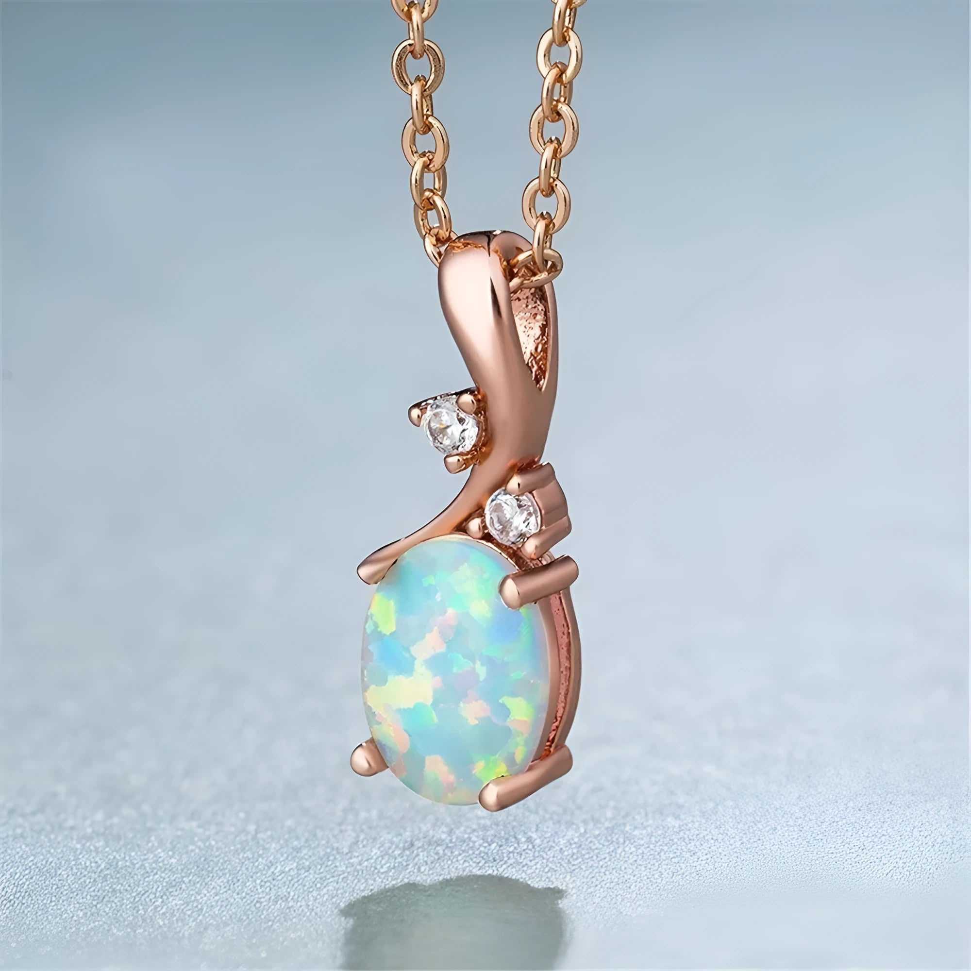 Water drop shaped opal pendant on adjustable chain necklace in rose gold or white finish