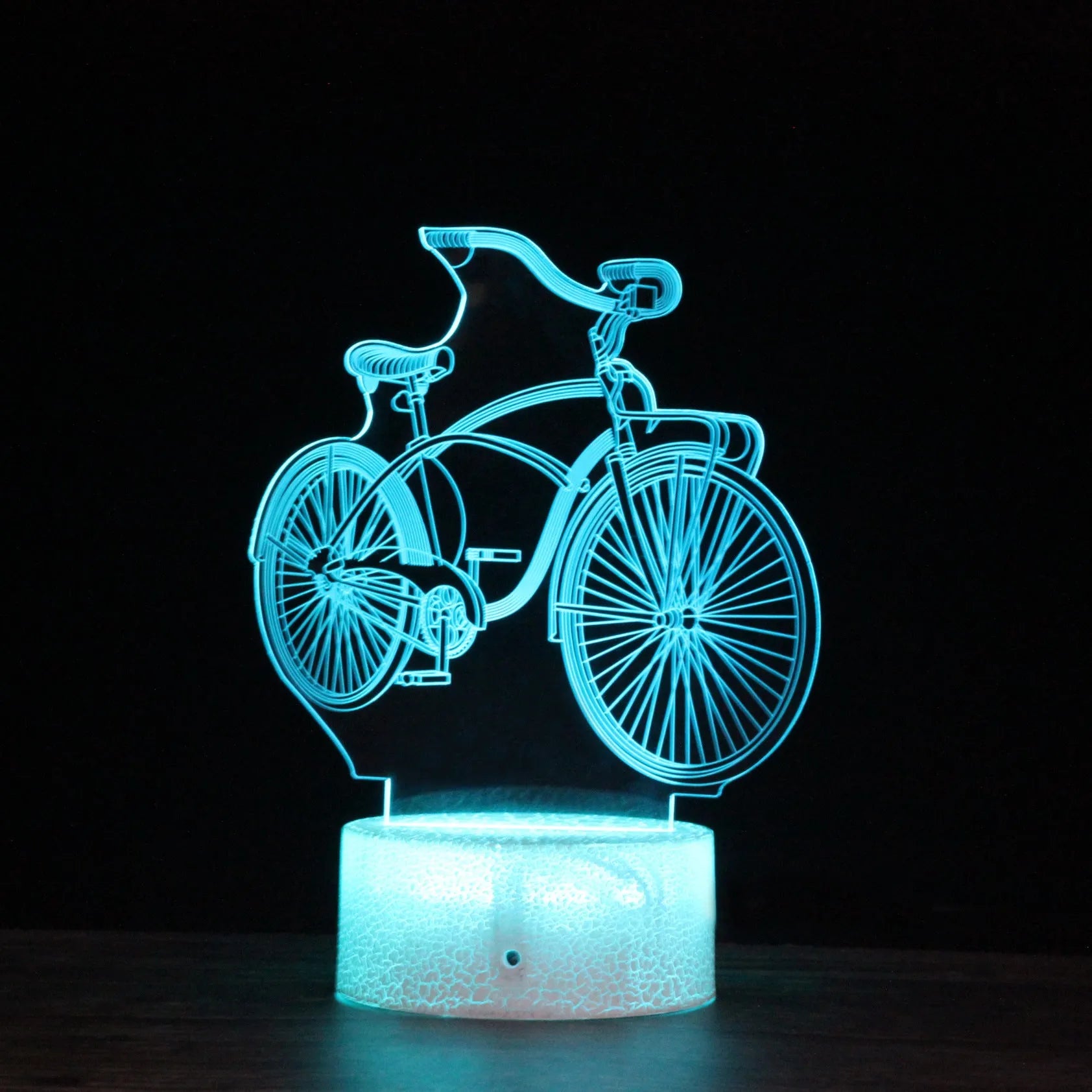 Bicycle series 3D night light with colourful LED glow on black base against dark background