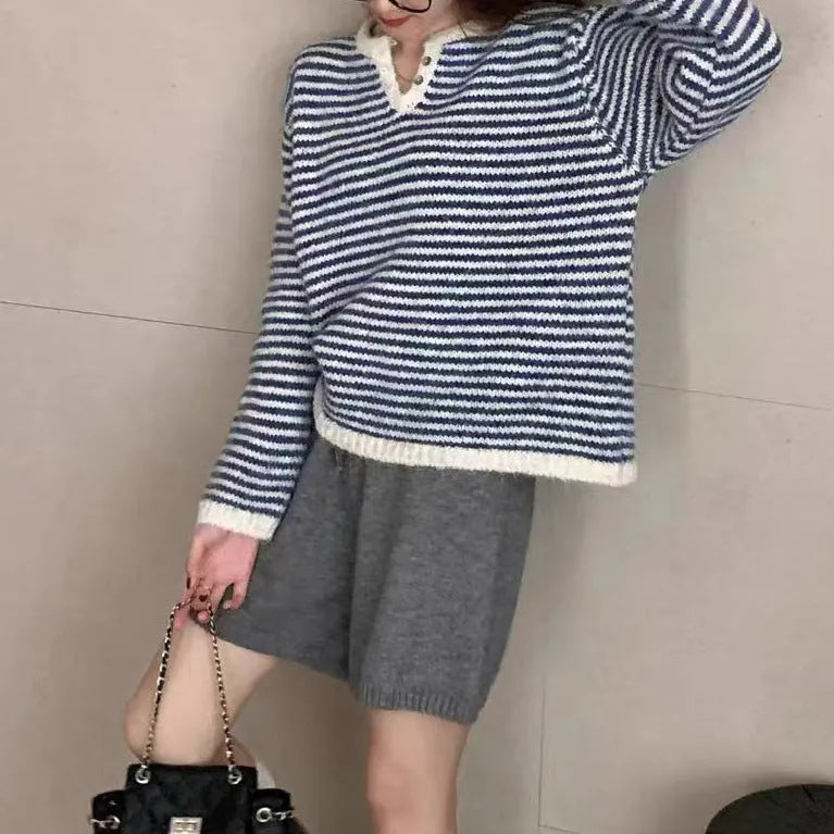 Red and blue striped women's cashmere pullover sweater on a hanger.