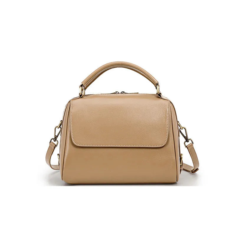 Women's genuine leather crossbody tote bag in apricot colour showing internal compartments and shoulder straps.