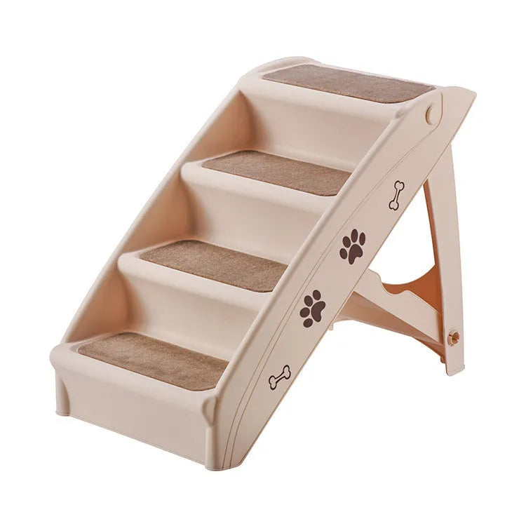 Foldable grey plastic pet stairs for small dogs and cats next to a sofa, with a non-slip mat visible.