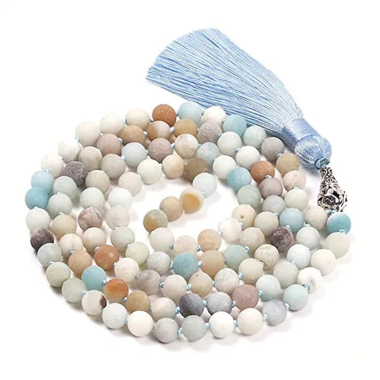 Long agate tassel necklace with geometric stone beads in various colours on a neutral background.