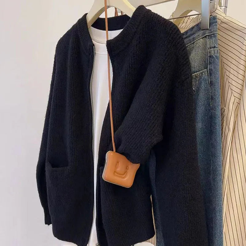 Beige viscose knit cardigan coat with long sleeves on a hanger.