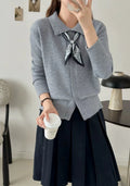 Beige cardigan sweater with a built-in lapel scarf and long sleeves laid flat