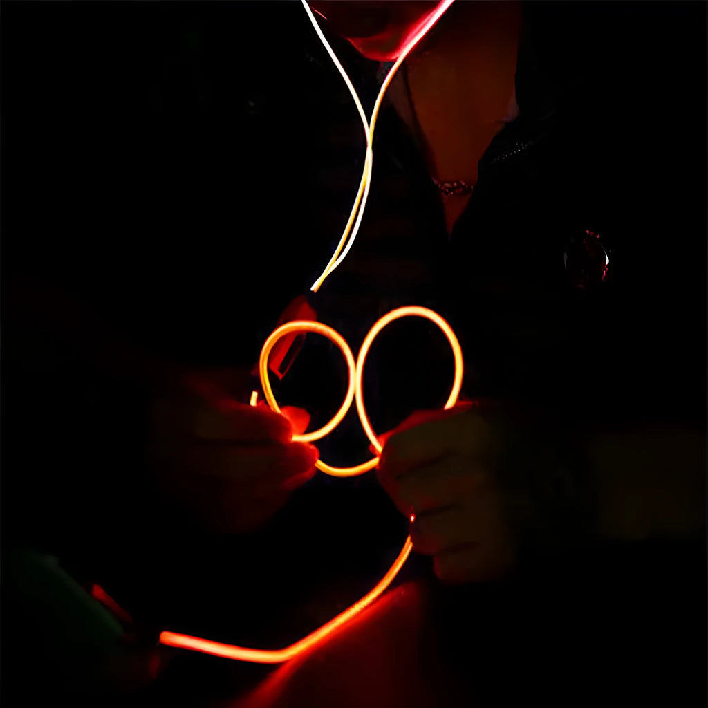 Blue LED light up earphones with 3.5mm plug and in-line remote control on a dark background