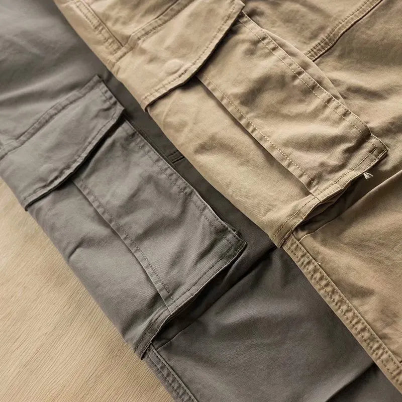 Man wearing khaki coloured multi-pocket cotton cropped work trousers.