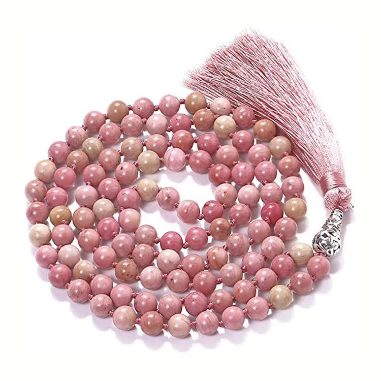 Long agate tassel necklace with geometric stone beads in various colours on a neutral background.