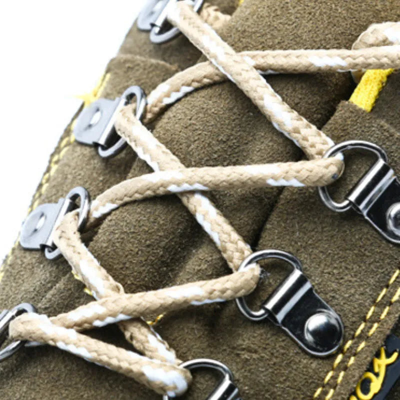 Bronze cow suede leather steel toe safety boots with non-slip sole on workplace surface
