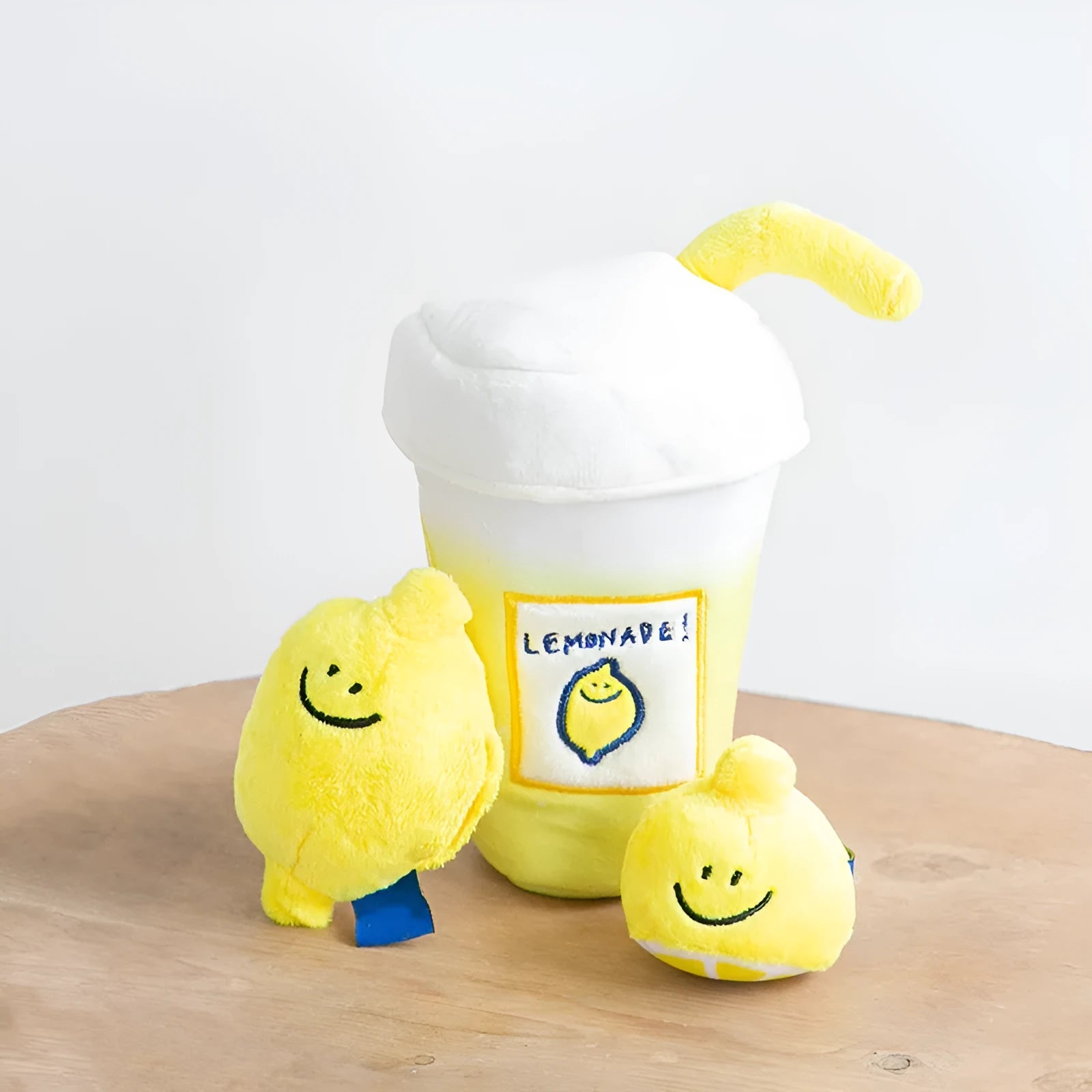 Yellow plush lemon tea cup pet toy with snack pocket, BB call squeaker, and separate cup component.