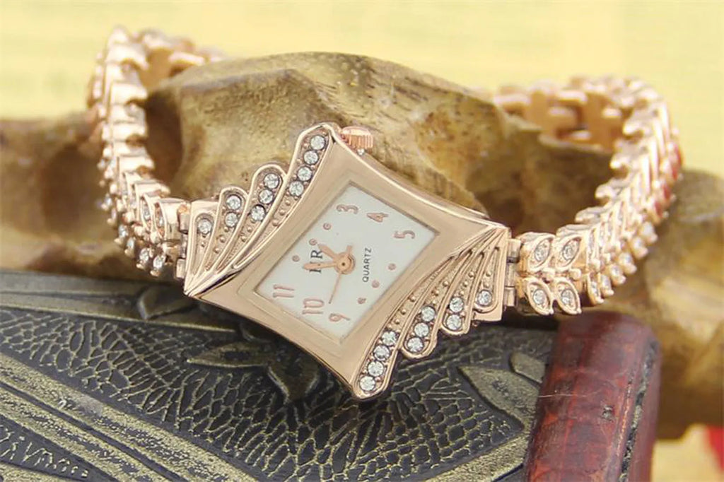 Stone paved wheat shaped metal wristwatch for women in rose golden colour with 2.5cm dial and 19cm band