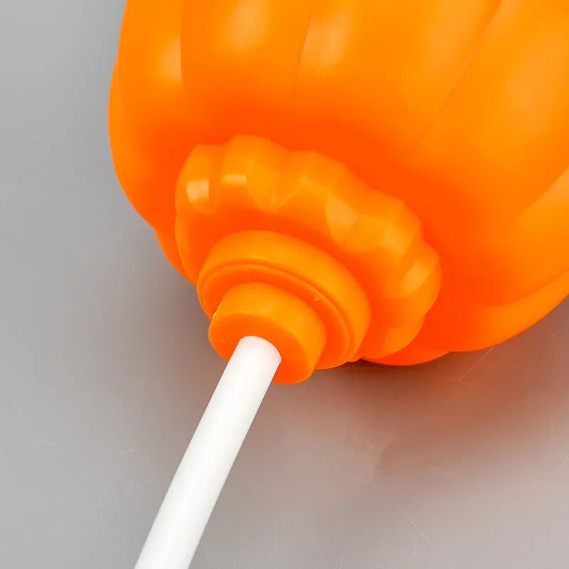 Plastic pumpkin-shaped lamp with USB charging cable, showing purple light option.