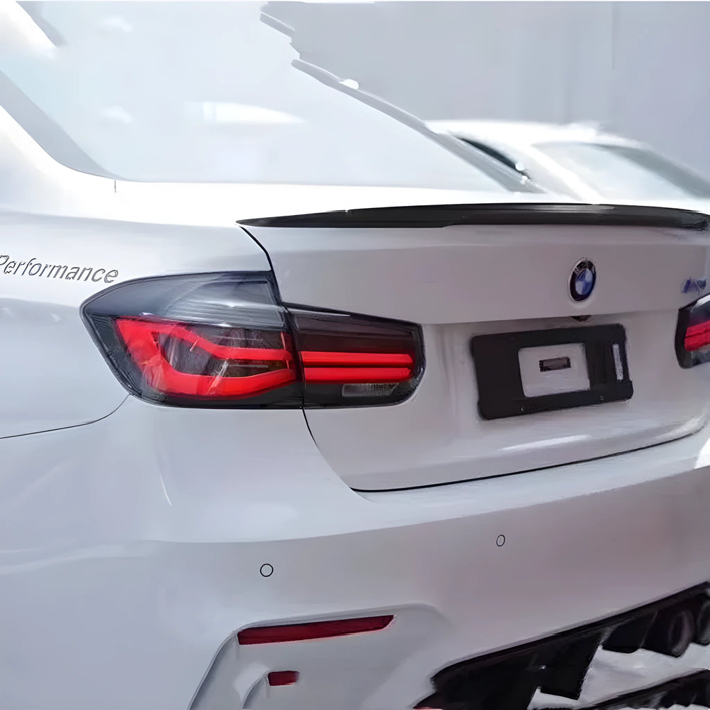 BMW 3 Series red and smoked black LED tail light assembly showing streamer design
