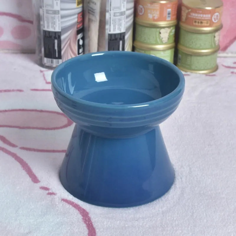 Black ceramic pet bowl with a raised foot and high neck guard for dogs and cats.
