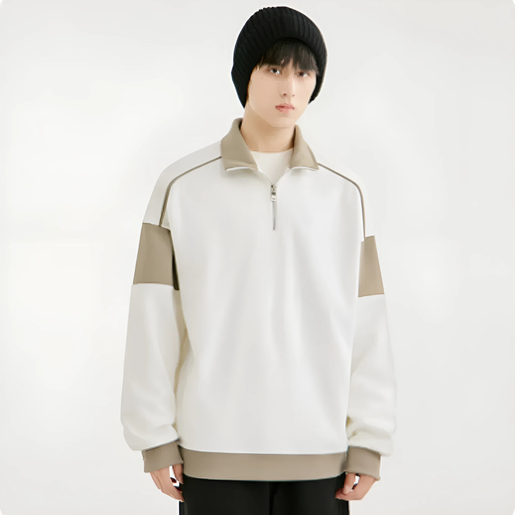 Man wearing a beige corduroy hooded sweater with loose lapels and drop shoulders.
