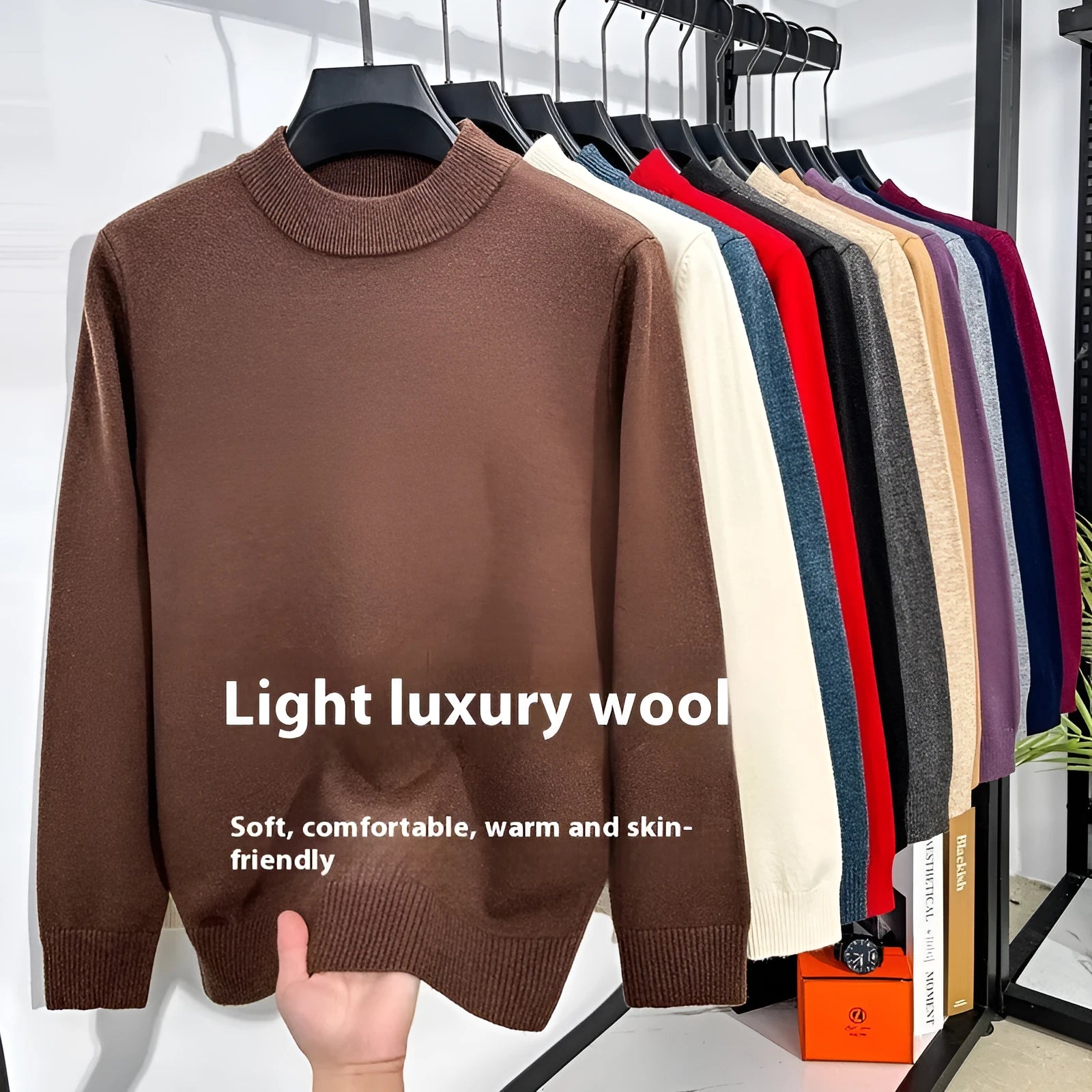 Men's solid colour fine yarn half-turtleneck long sleeve pullover on a hanger.