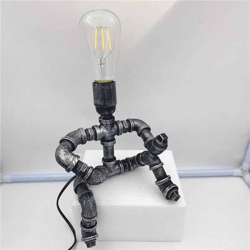 Industrial vintage table lamp constructed from iron water piping in a retro colour