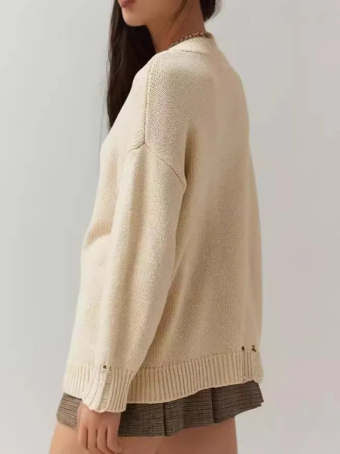 Women's milky white beige acrylic Jacquard pullover sweater with round neck and long sleeves.