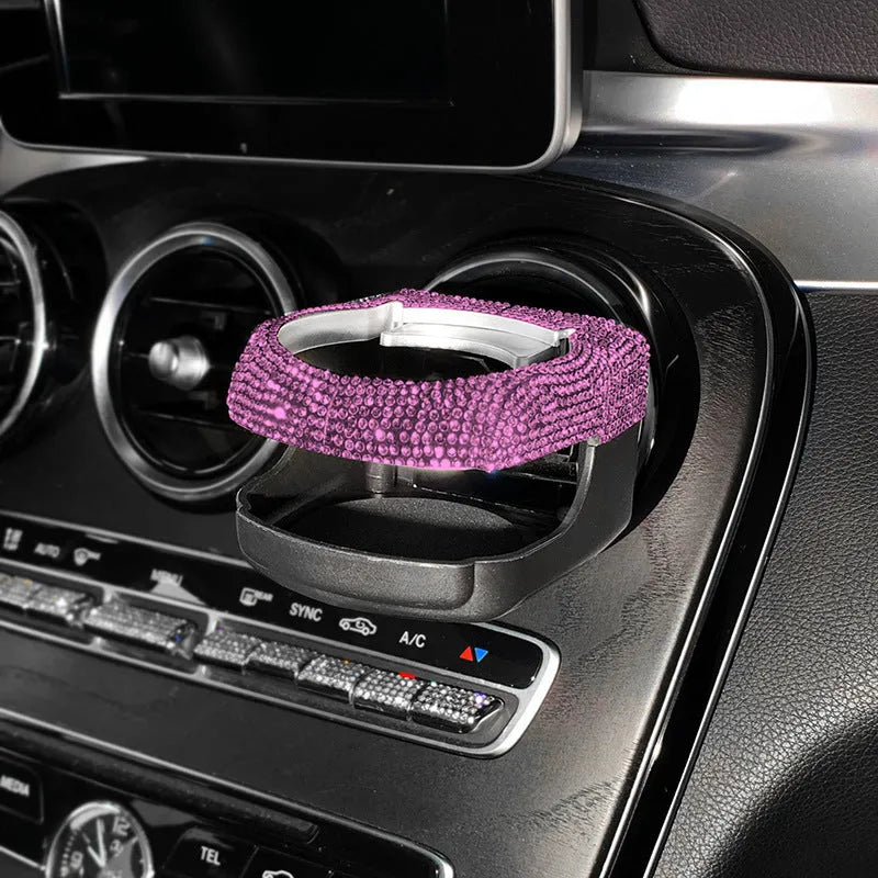 White diamond decorated ABS plastic car vent cup holder mounted in a car air vent.
