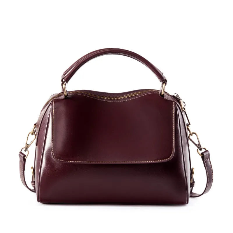 Women's genuine leather crossbody tote bag in apricot colour showing internal compartments and shoulder straps.