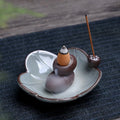 Square purple clay ceramic reverse flow incense burner with lotus and plum blossom decoration.