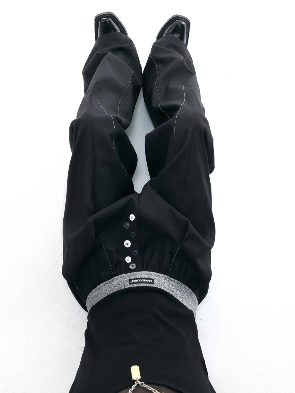 Straight-leg high-waist trousers with button open line detailing in black and grey colours