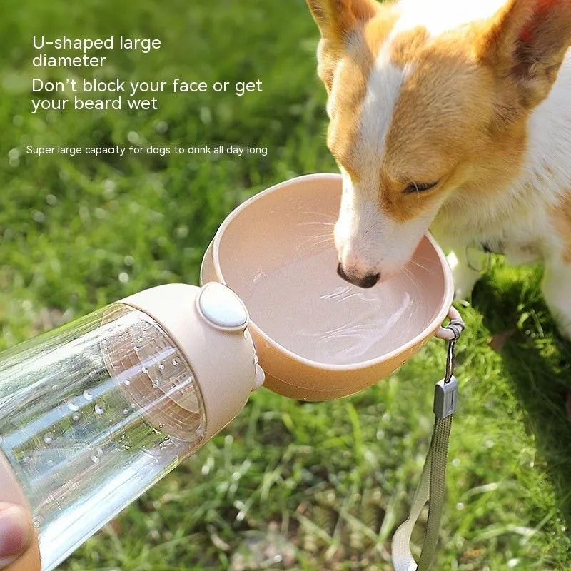 Portable dog water bottle with an attached feeding bowl in yellow, for outdoor travel.