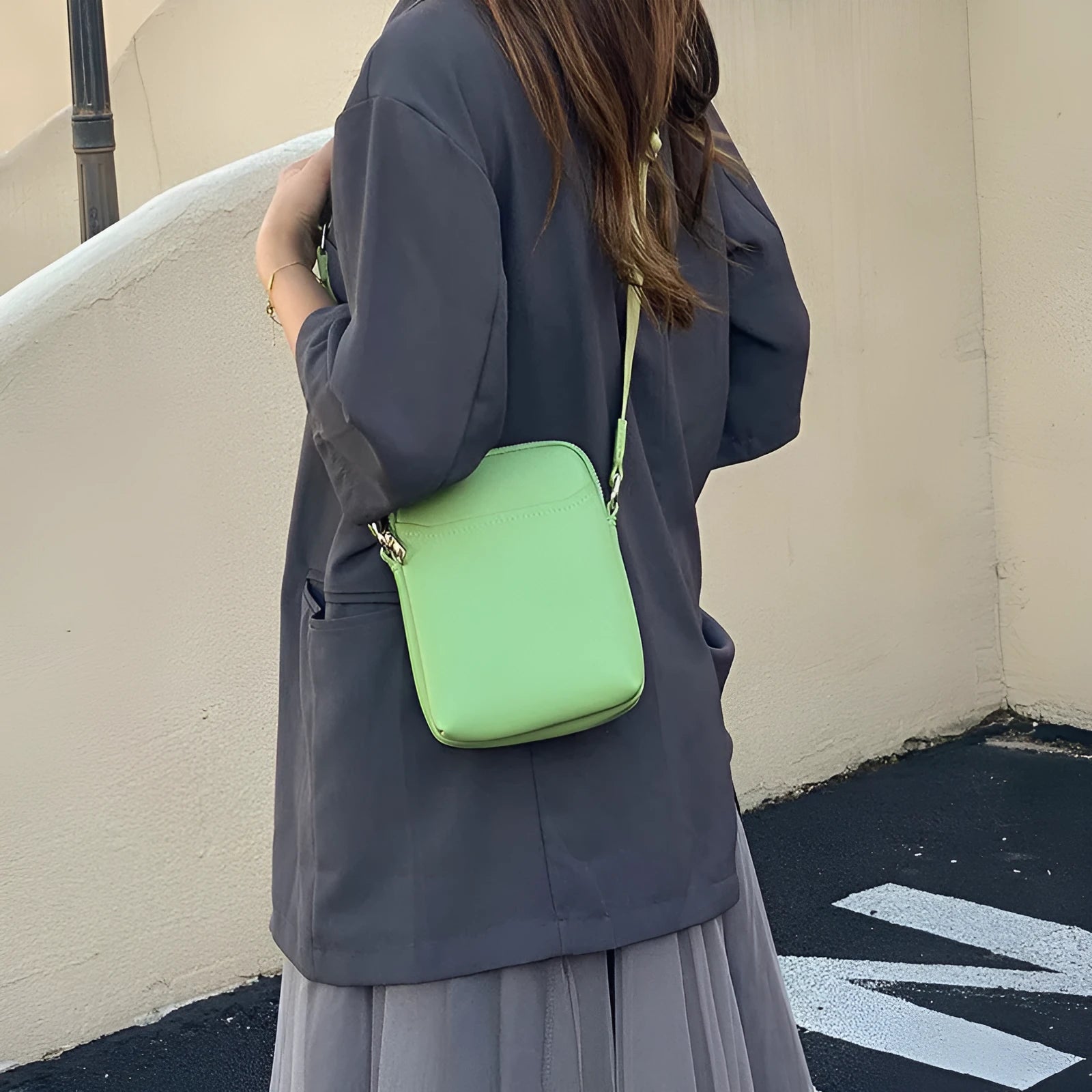 Solid colour small crossbody mobile phone bag in beige, showing front view and adjustable strap.