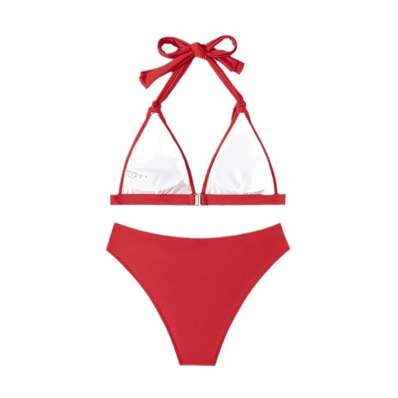 Red women's halterneck bikini set with lace-up front and matching split shorts.