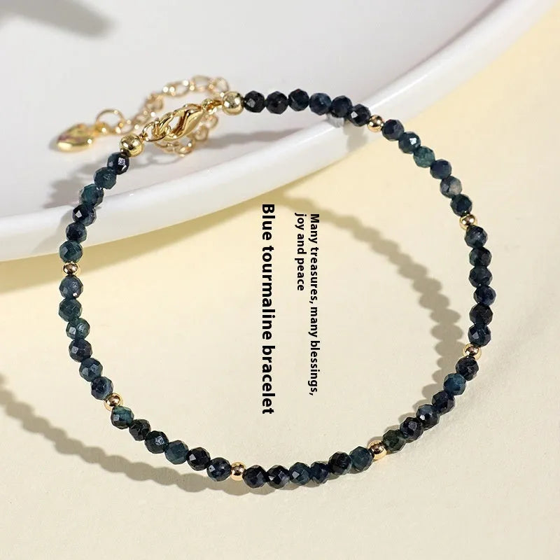 Blue tourmaline bracelet with 3mm beads and spacer bead design on wrist