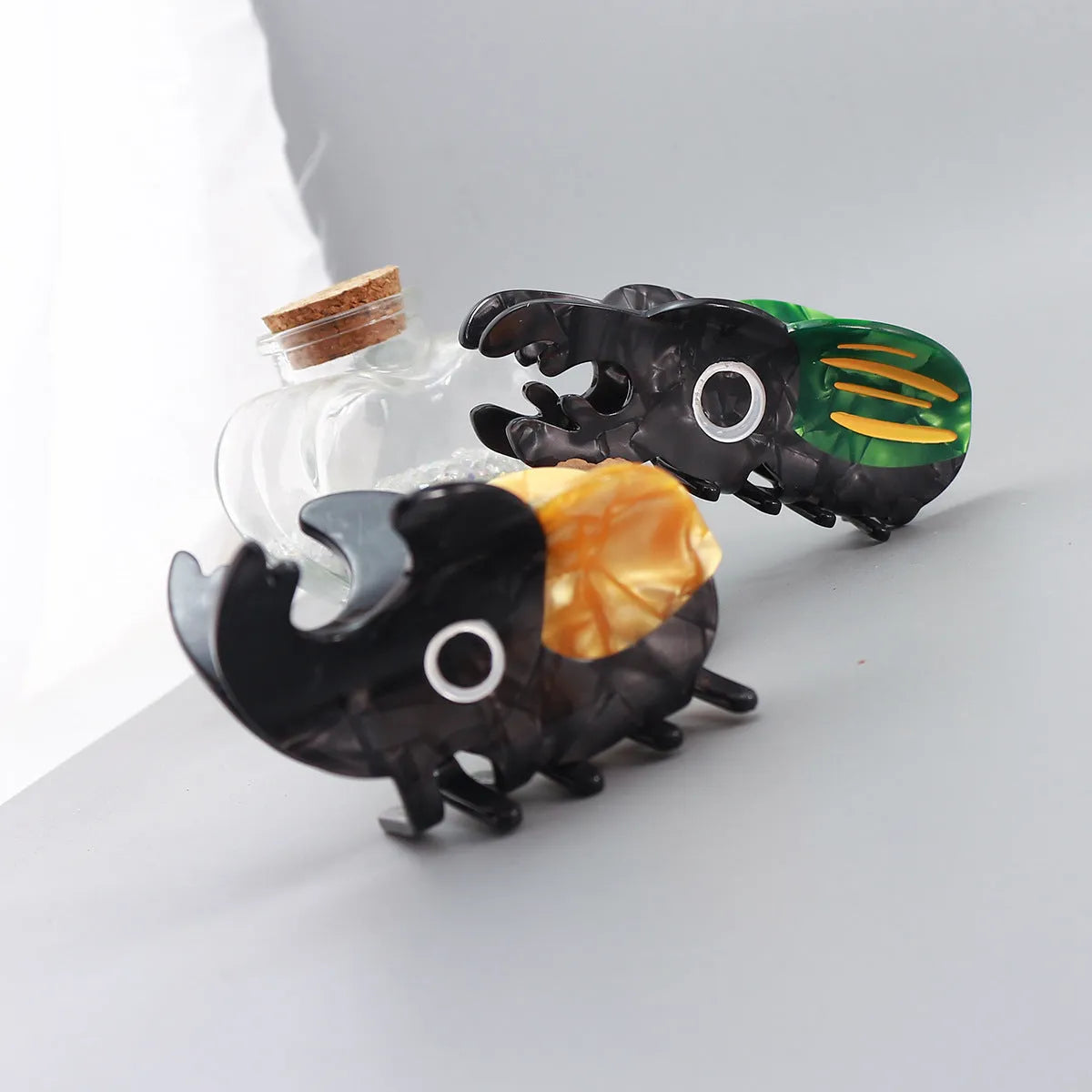 Handmade cellulose acetate hair clip with cartoon beetle design in green or orange colour options