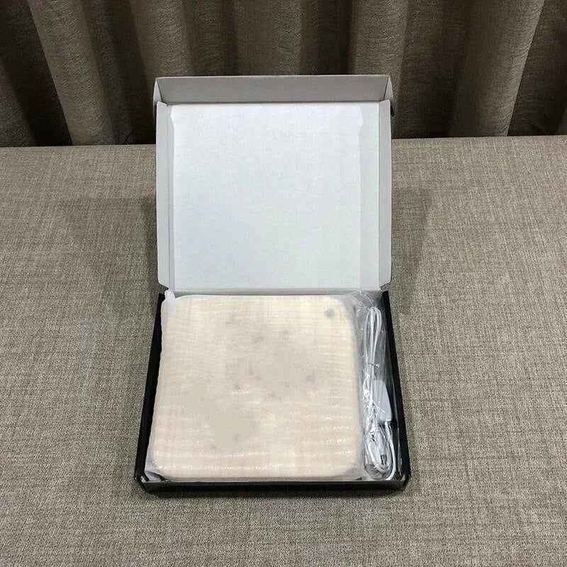 Square wooden LED atmosphere lamp with warm white light and USB cable on a desk