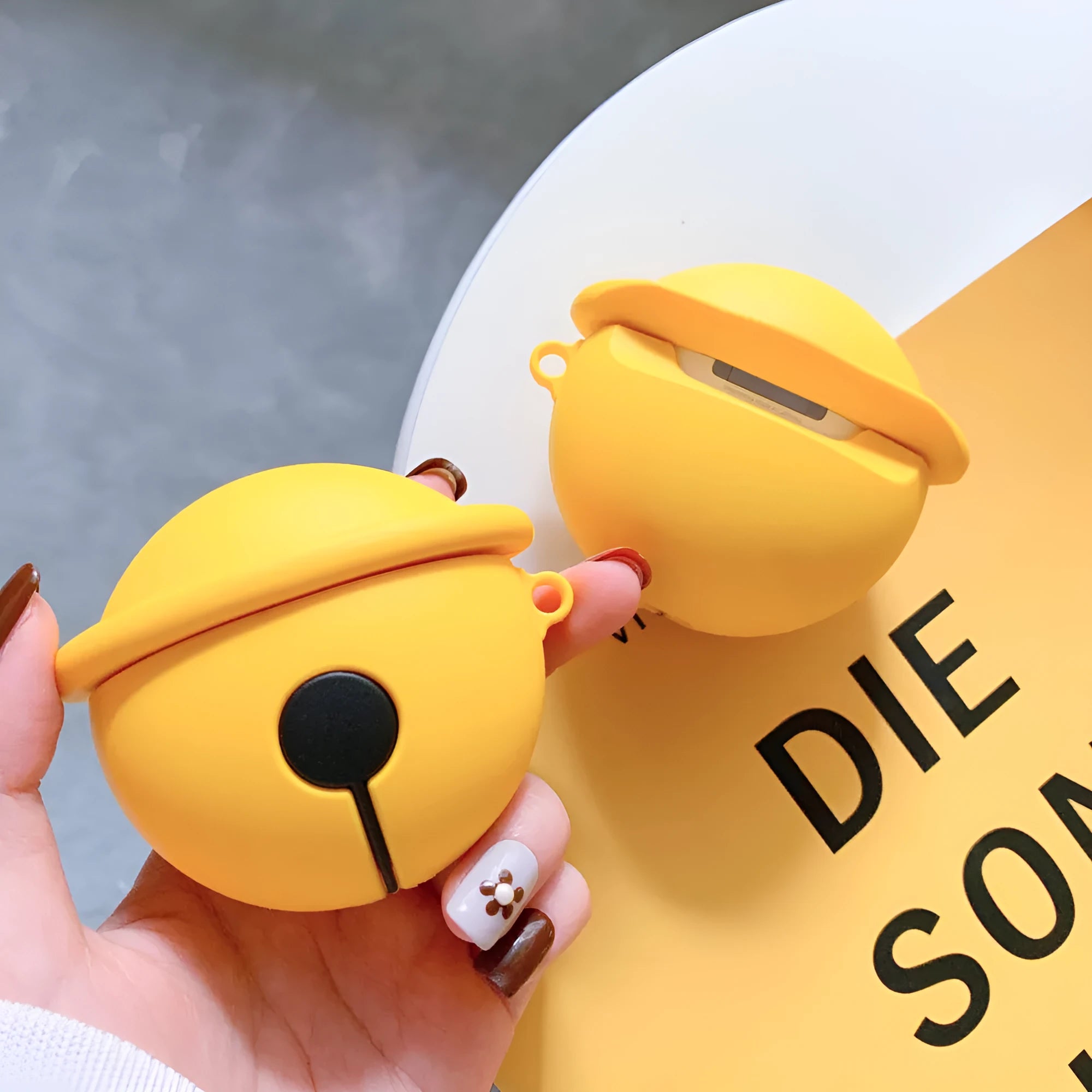 Yellow silicone bell-shaped protective case for AirPods 1 and 2 generation.
