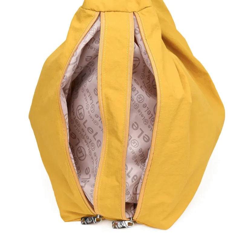 Heart-shaped soft nylon crossbody bag for women in black, blue, khaki, or yellow.