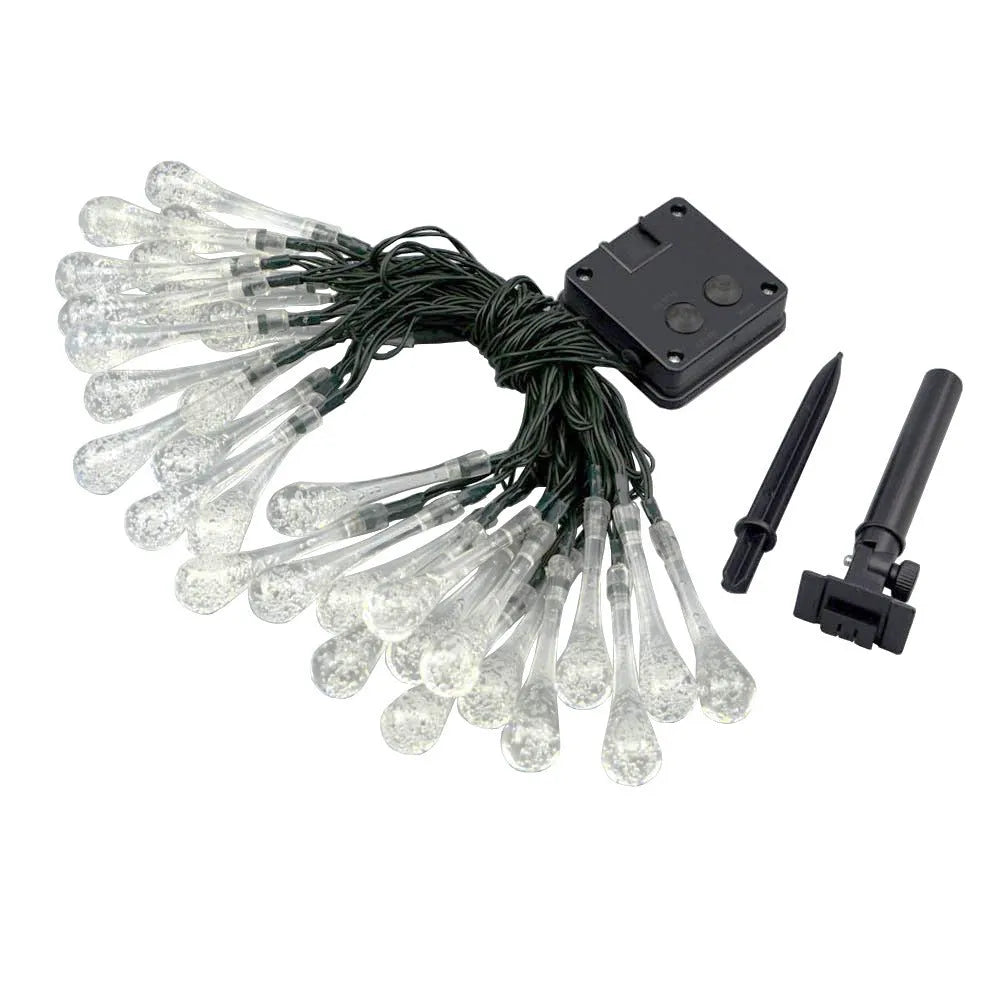 Solar-powered water drop LED string lights in garden with ground spike and bubble pendant design