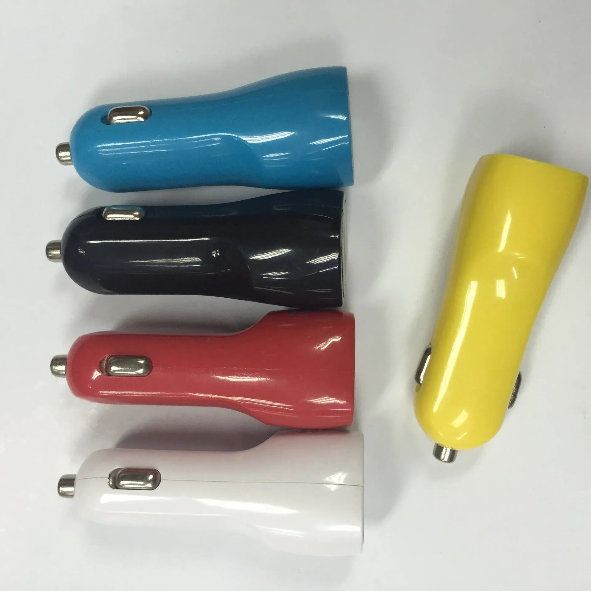 Dual-port USB car charger with blue LED indicator showing duckbill design for vehicle cigarette lighter sockets