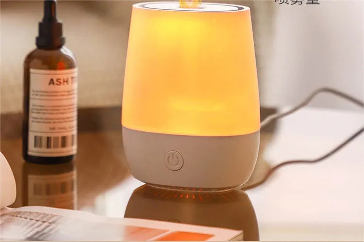 White USB aroma diffuser humidifier with flickering flame effect light on a wooden surface.