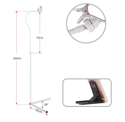 Black bedside mobile phone holder with universal clip and adjustable overhead support shelf mounted on bed frame