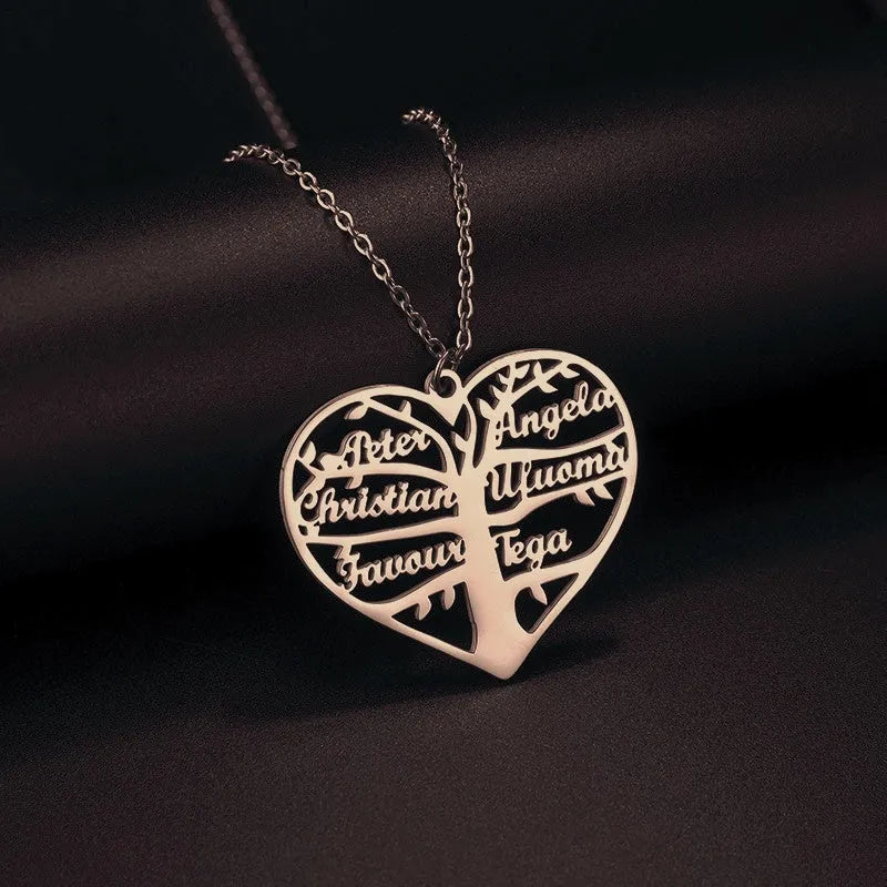 Women's custom name necklace with stainless steel heart and tree pendant on a chain.