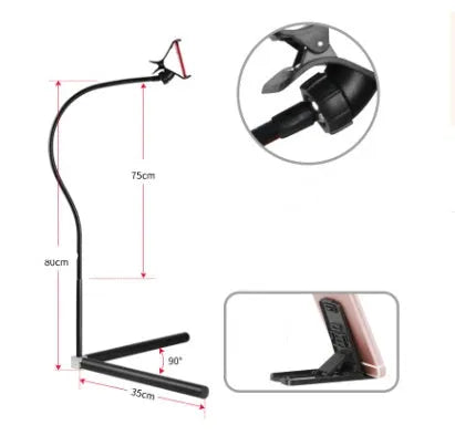 Black bedside mobile phone holder with universal clip and adjustable overhead support shelf mounted on bed frame