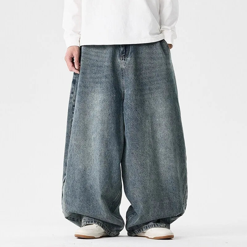Men's plus size light blue wide leg baggy jeans on a neutral background